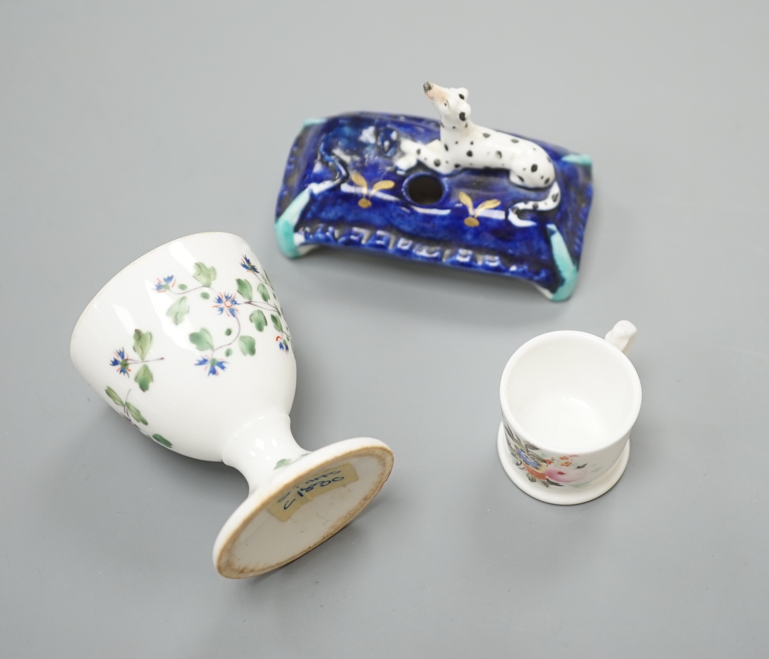 A mid 19th century Staffordshire porcelain Dalmatian pen holder and a cornflower spray egg cup and a miniature mug, tallest 6cm